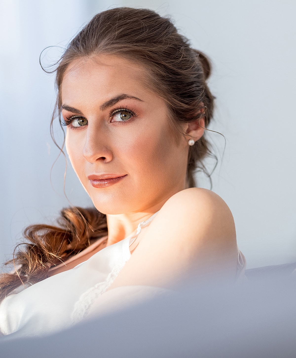 Woman with elegant hairstyle and natural makeup.