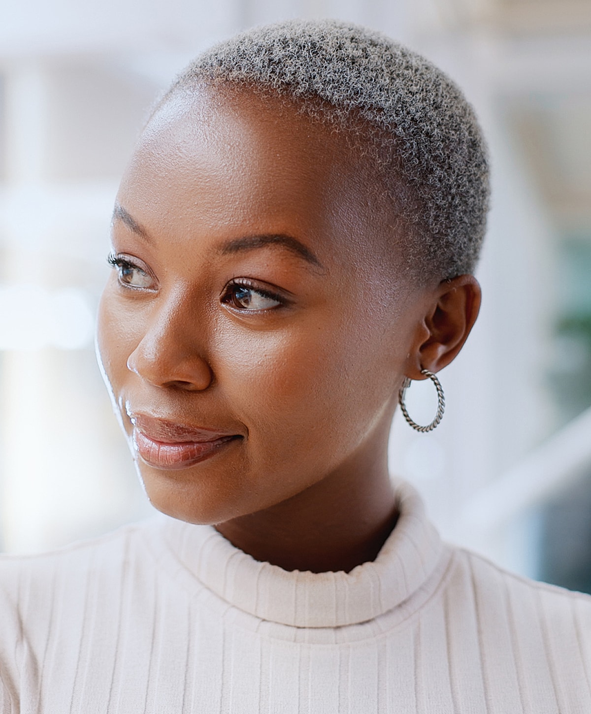 Smiling woman with short, silver hair.