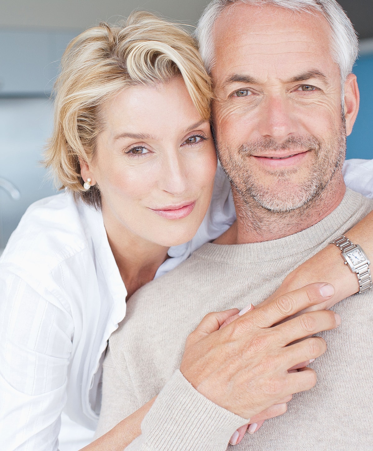 Couple smiling together in a cozy setting.