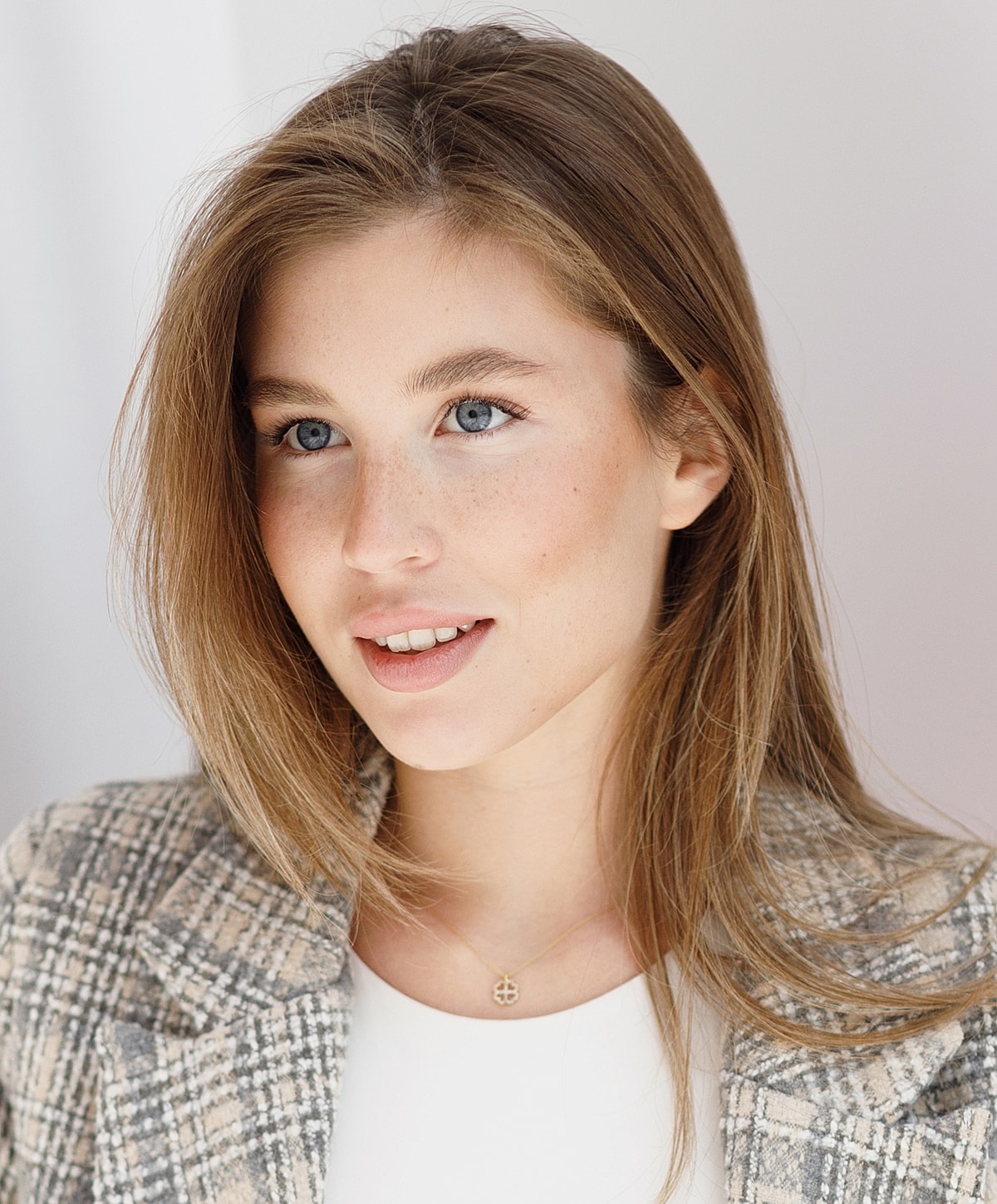 Young woman with blue eyes and light brown hair.