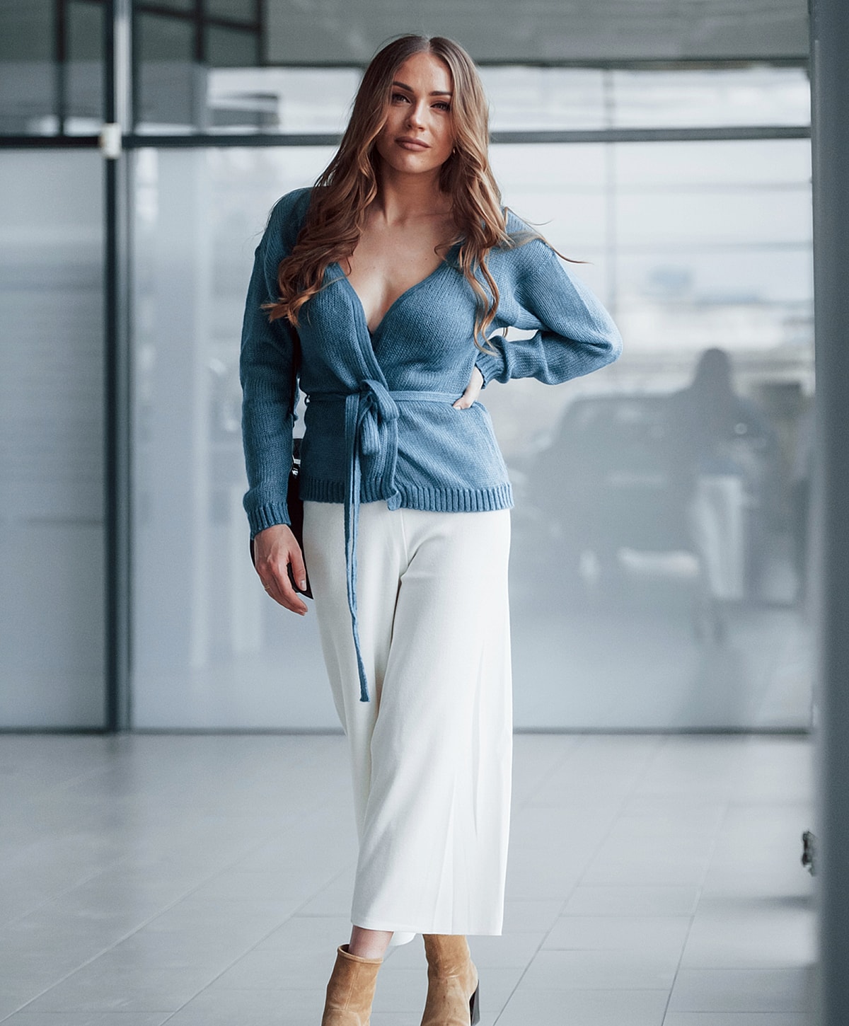 Woman in stylish outfit in modern interior.
