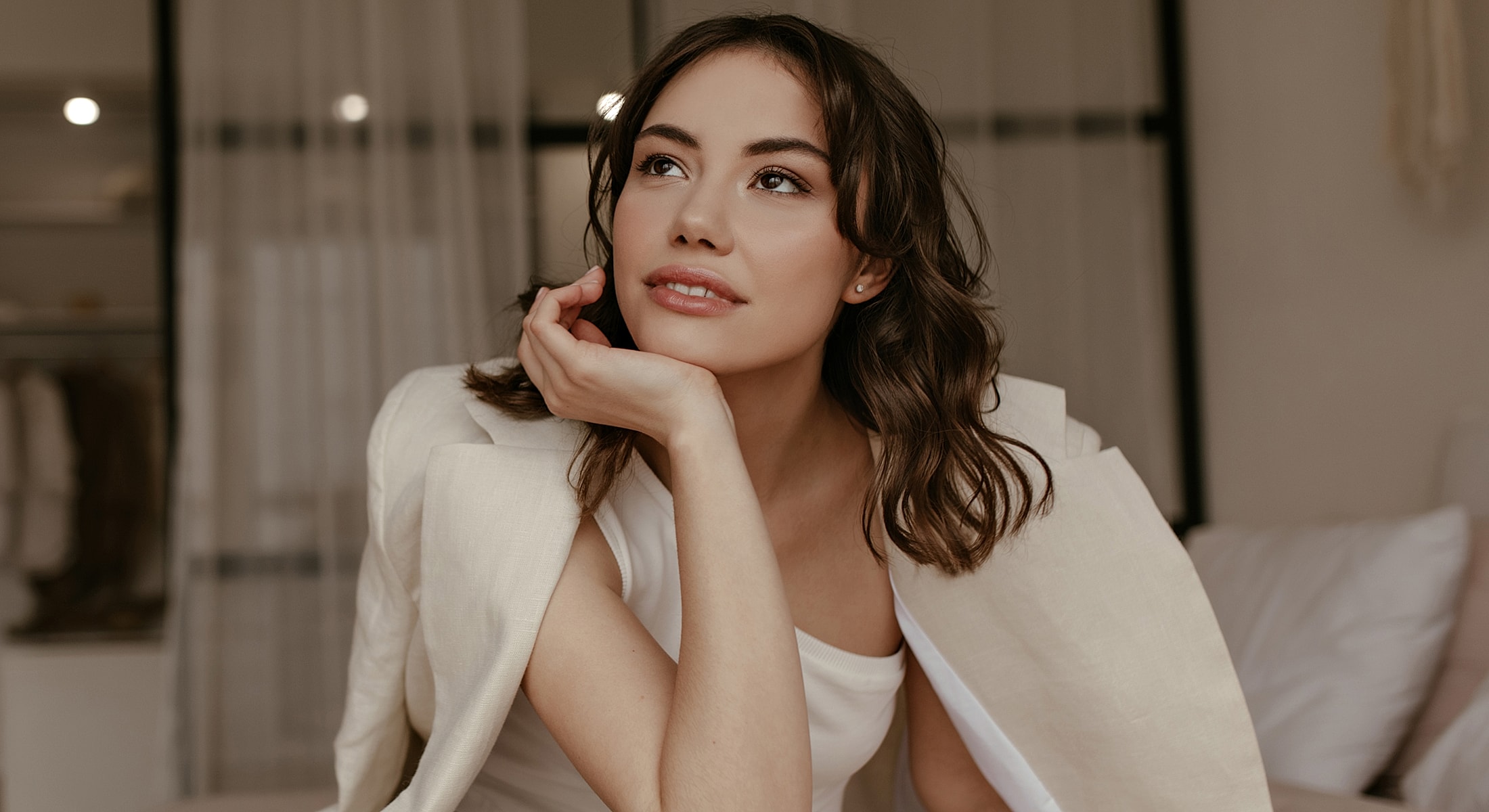 Woman with thoughtful expression in cozy setting